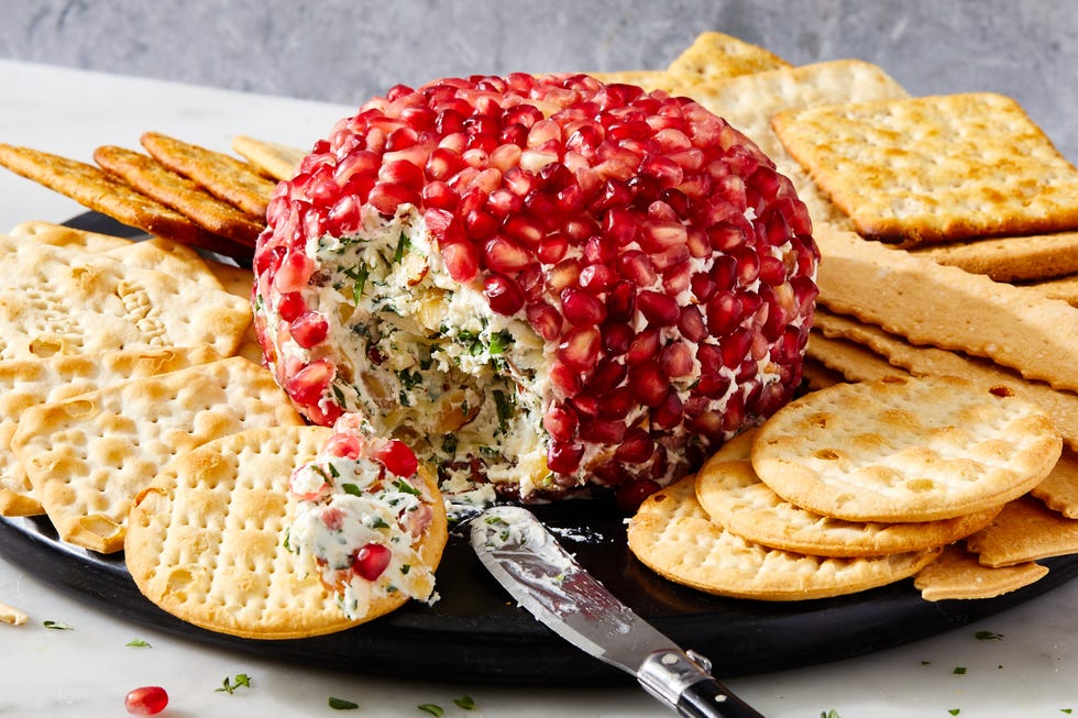 fancy christmas cheese ball covered in fresh pomegranate seeds