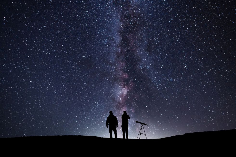 fantasy landscape, two hiker standing on the hill, and looking at the milky way galaxy with telescope