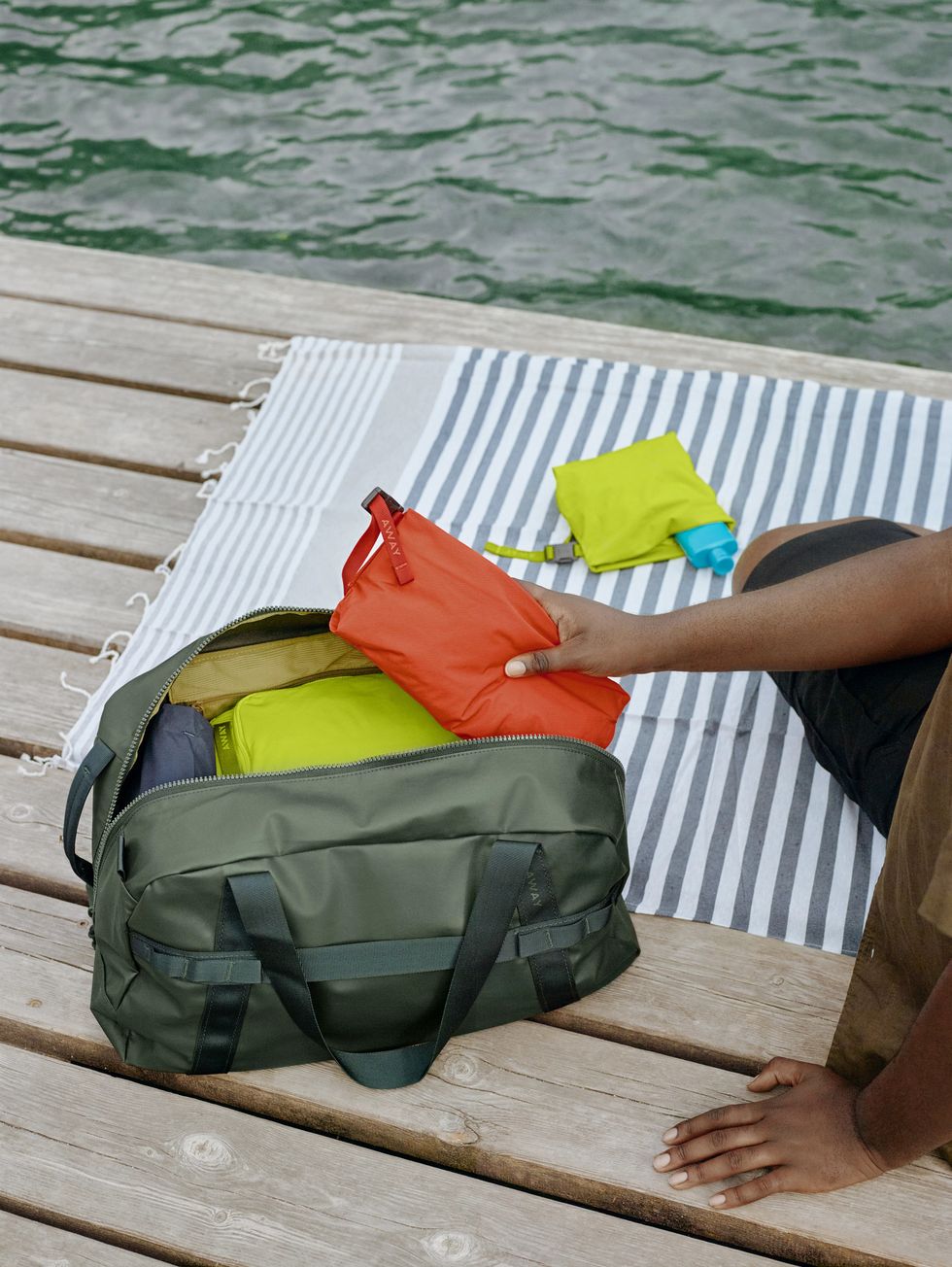 an away duffle bag filled with packing cubes in a roundup of away luggage outdoor launch 2022