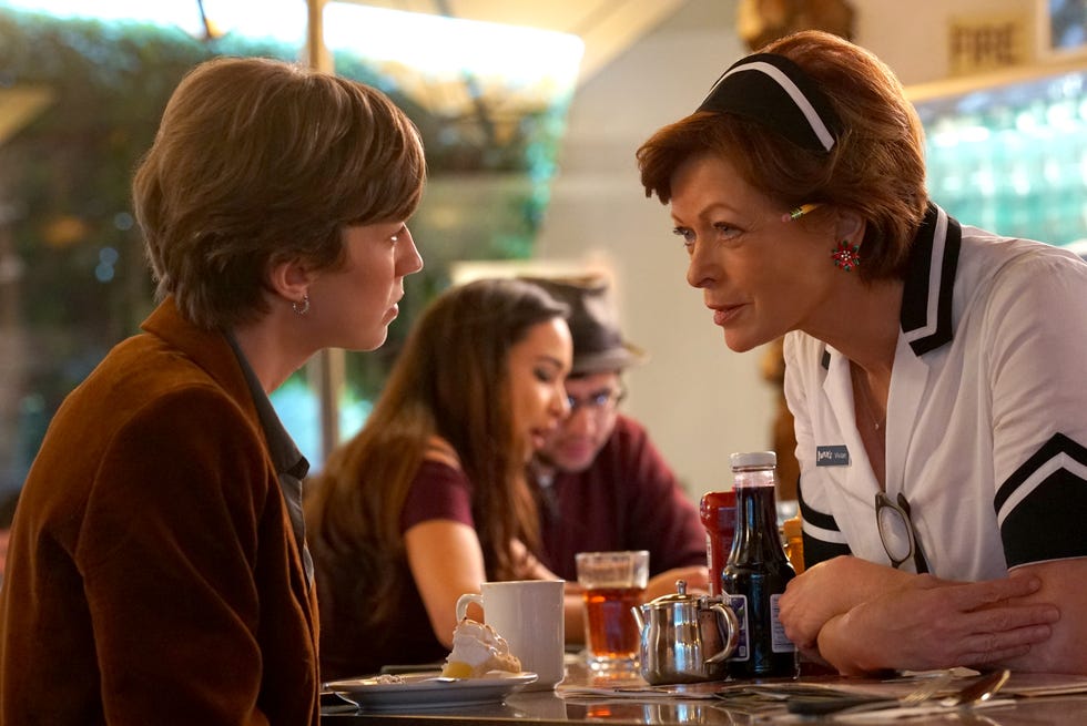 two women speaking at a counter