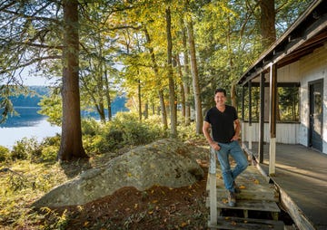 jonathan knight takes a break while examining one of the lakeside cabins at the camp that jonathan and his brother jordan are renovating for their extended family to enjoy, as seen on farmhouse fixer camp revamp