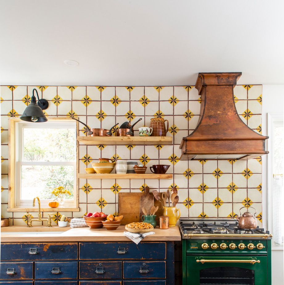 discovered at a barn sale this kitchens blue workbench sets the rustic pieced together feel of this galley kitchen as this is a departure from modern farmhouse style with its deep colors in the stove and cabinets and even the copper hood that lets this small space live large