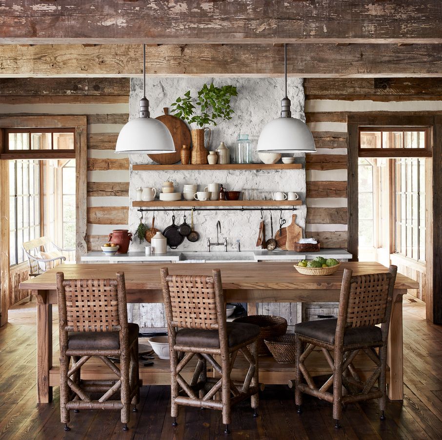 reclaimed wood graces the floor and ceiling and center of the kitchen which features a custom island crafted from antique white oak that is paired with rustic woven back counter stools