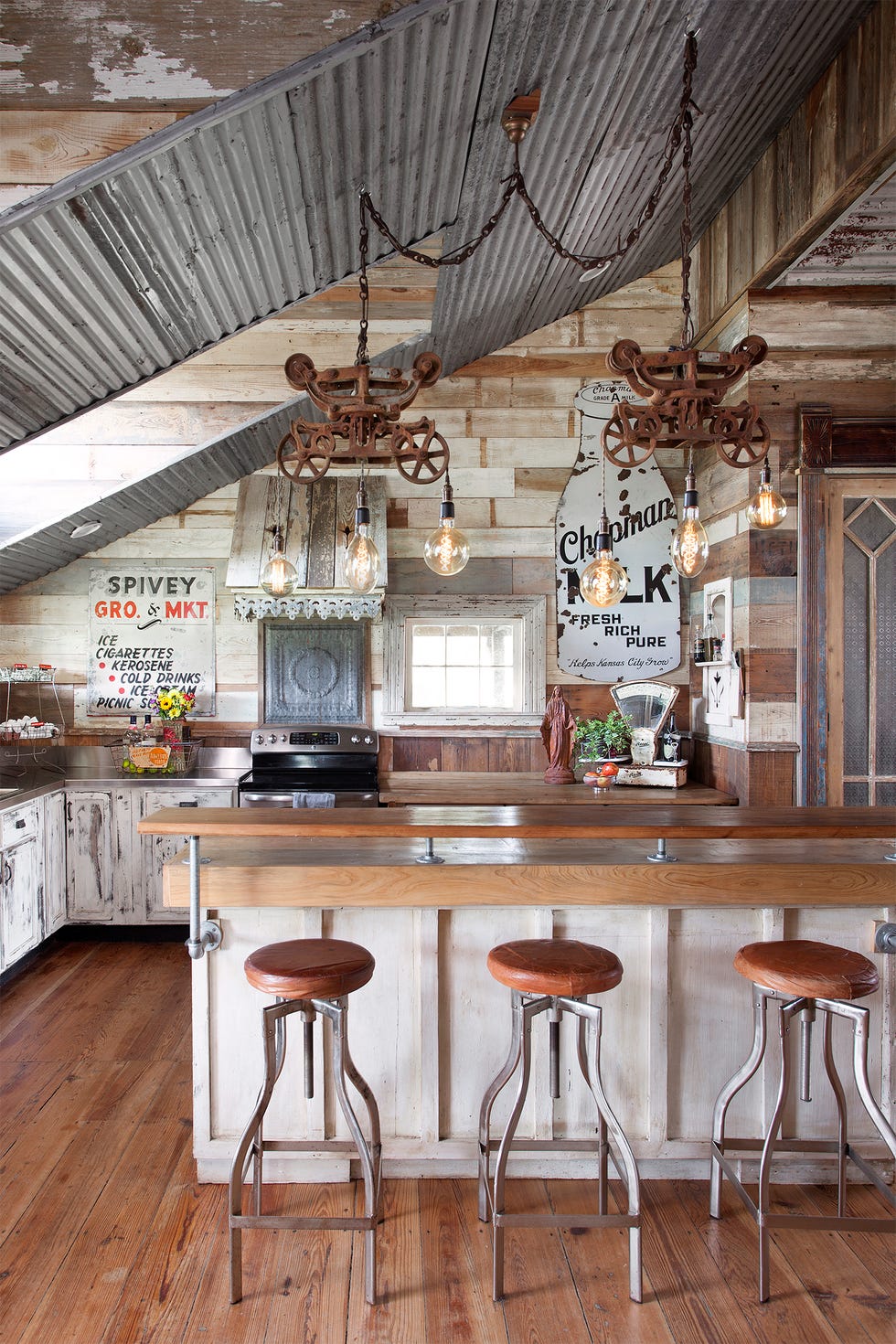 a farmhouse kitchen using reclaimed wood and lighting and signage to decorate