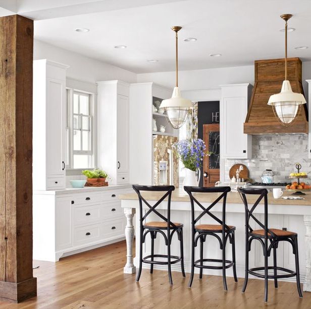 a white farmhouse kitchen ideas with salvaged wood details in the range hood