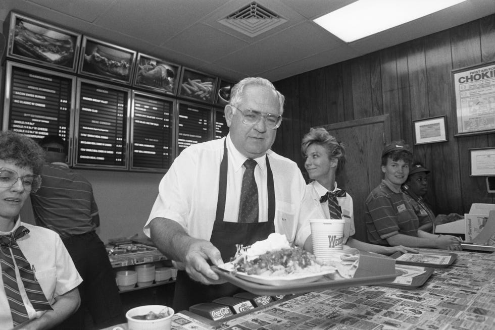 dave thomas holding a tray of food