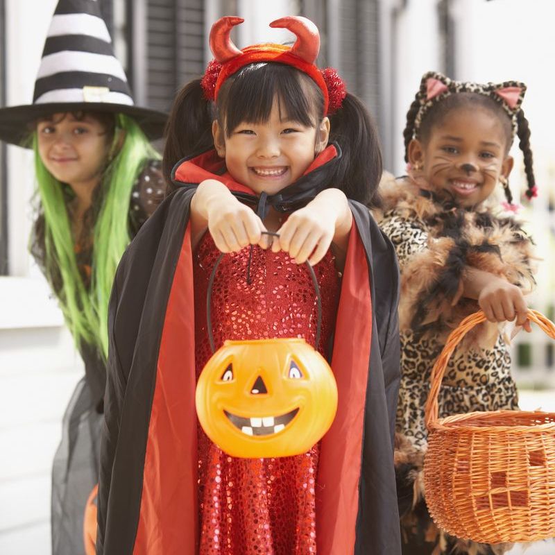 halloween trivia three girls dressed up as a witch devil and cat