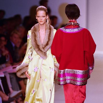 two models wearing silk robe and coat on the runway