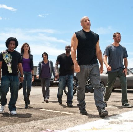 dom and his team walks with tough expressions on their faces in a scene from fast five