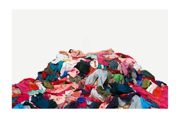 woman laying on pile of clothing