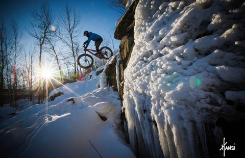 A rider drops in on lift-served winter fat bike trails at Duluth, Minnesota’s Spirit Mountain.