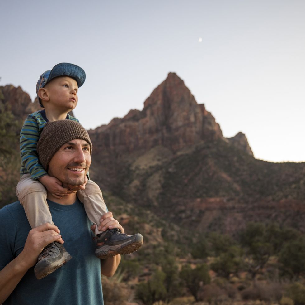 a father and his son hiking a scenic trail