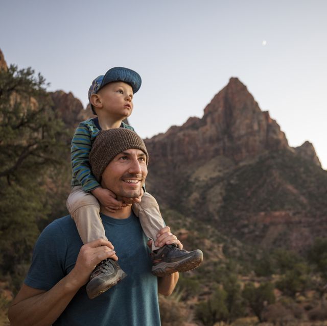 a father and his son hiking a scenic trail