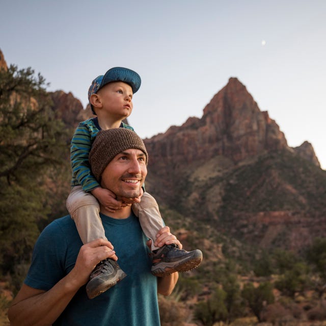 a father and his son hiking a scenic trail