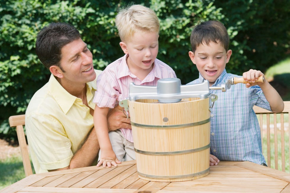 father and sons making ice cream outdoors in family friendly labor day activities