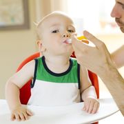 Father applying medicine to son (12-17 months)