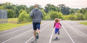 father daughter running on outdoor track