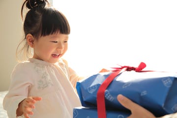 father giving a present to his toddler daughter