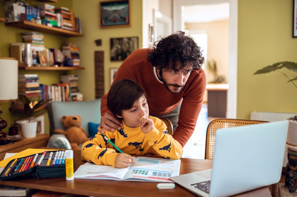 father helping his son with schoolwork