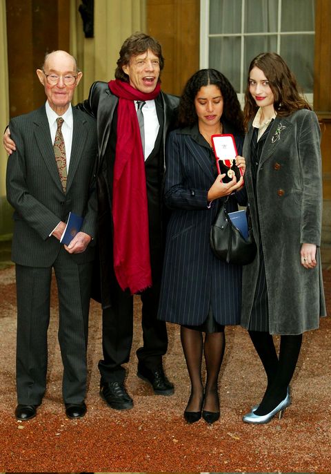 sir mick jagger smiles for a photo with his father and daughters