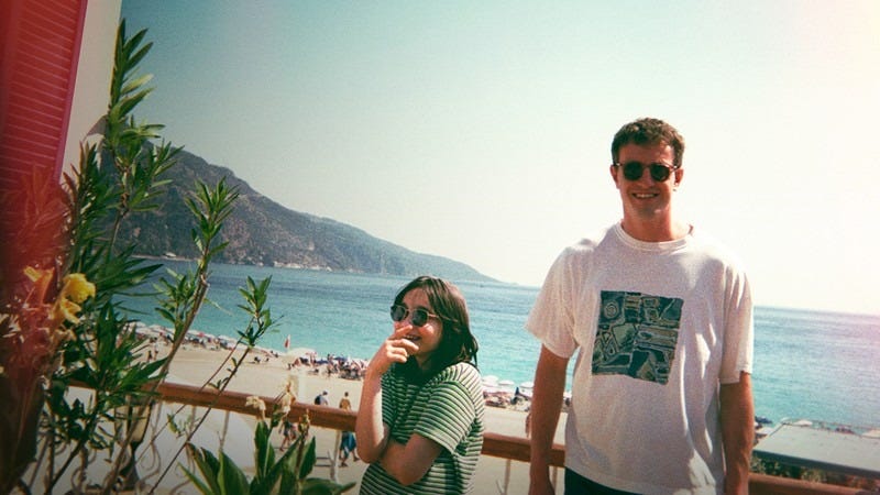 calum and sophie look happy in the sunshine in a scene from aftersun