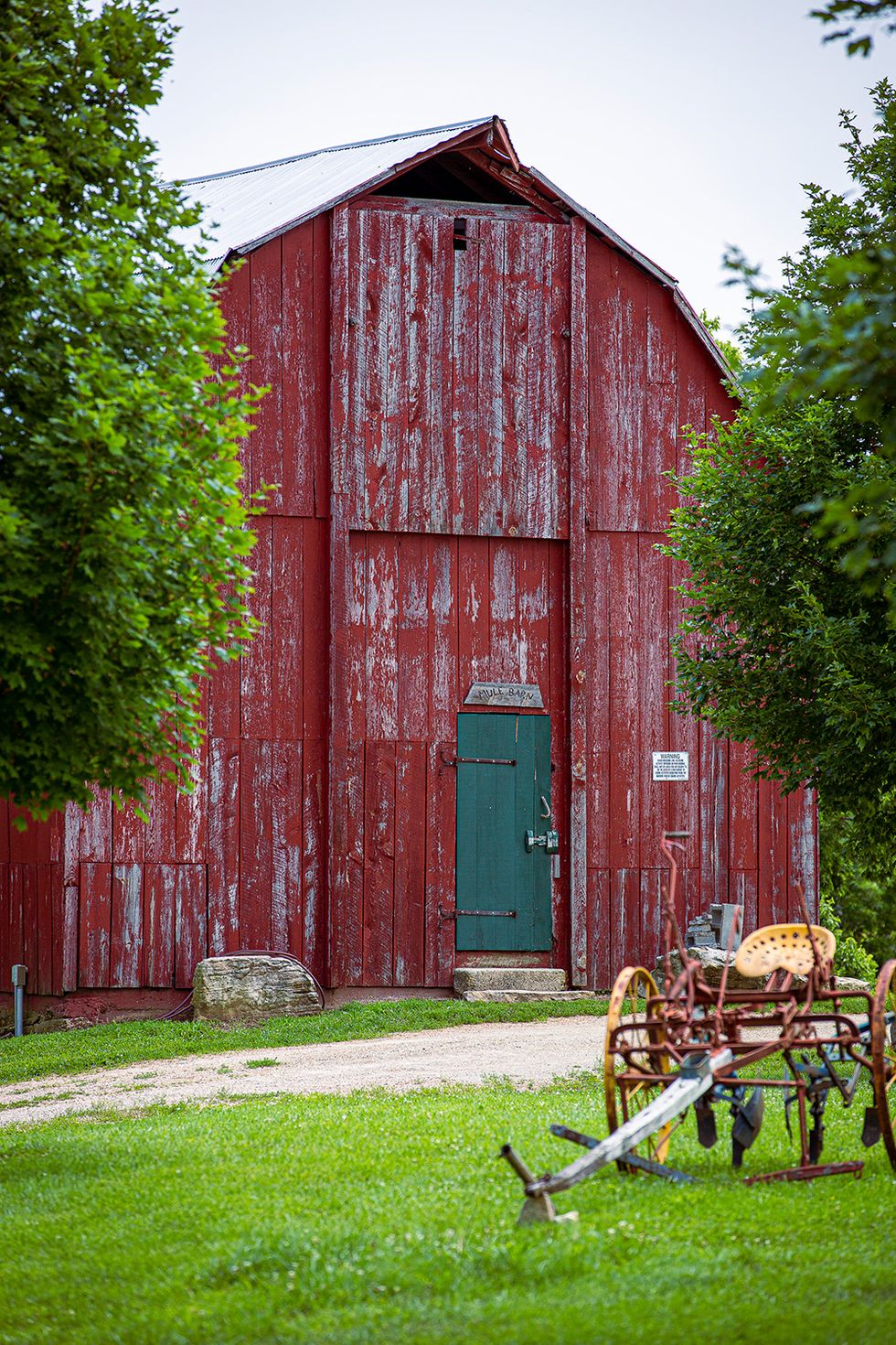 rustic red barn with green door
