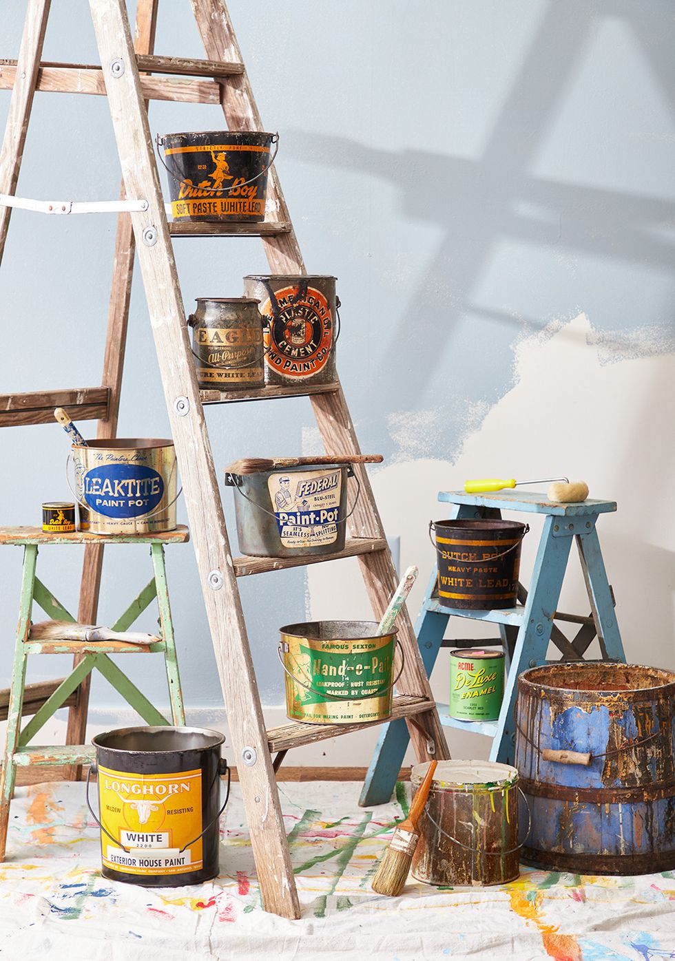 vintage paint pales stacked on step ladders