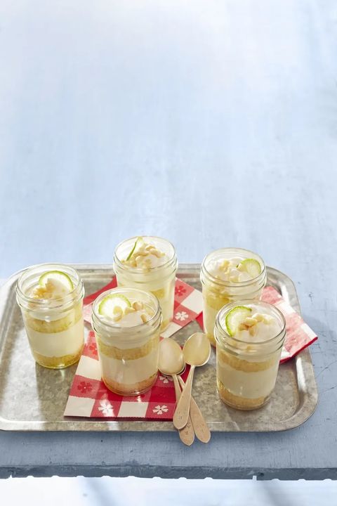 key lime cakes in a jar on metal tray with red napkins and spoons