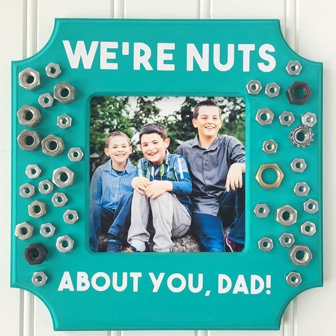 The frame has metal nuts of various sizes glued on it and contains a message saying you care about your dad.