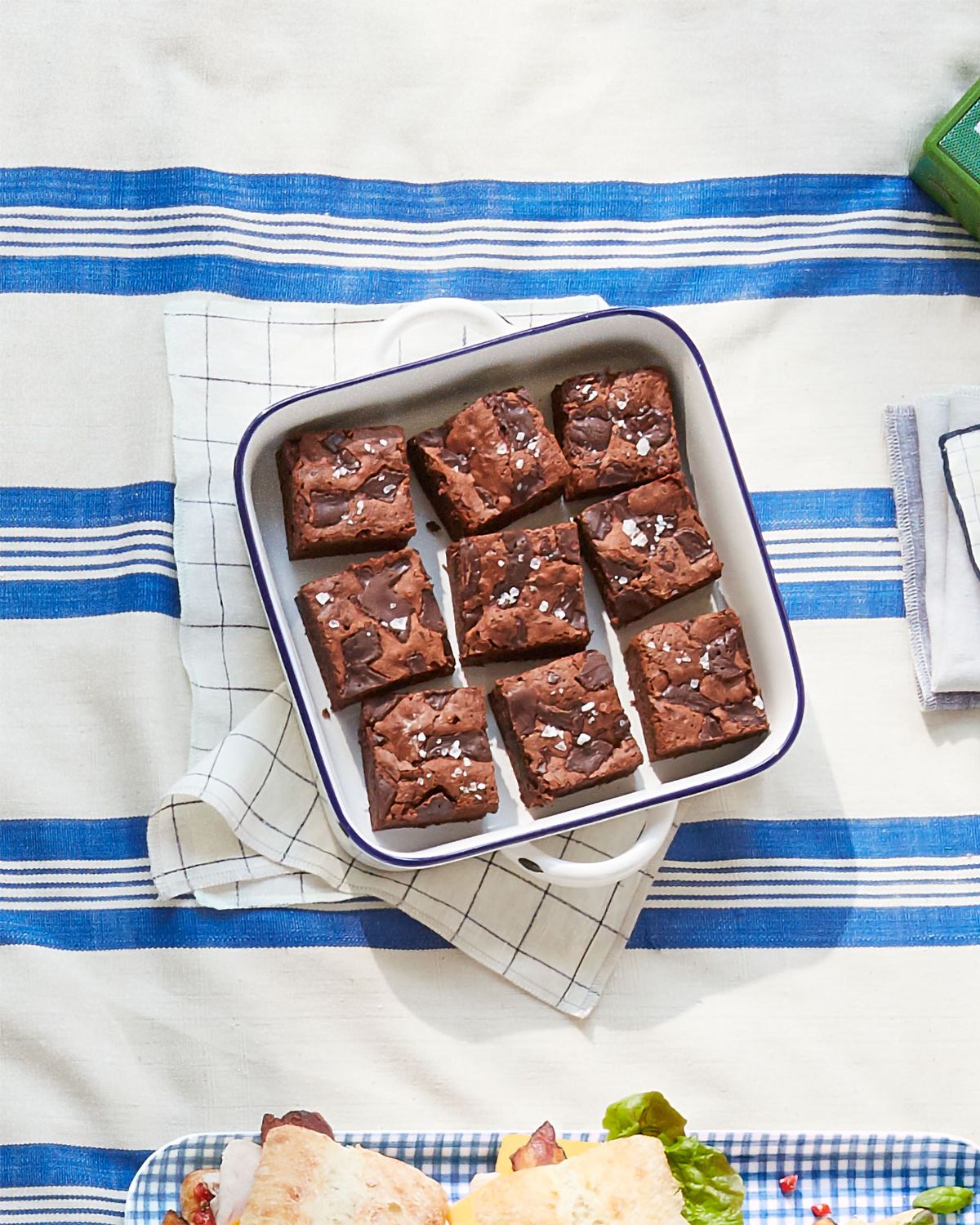 fudgy stout brownies in a tray on a picnic blanket