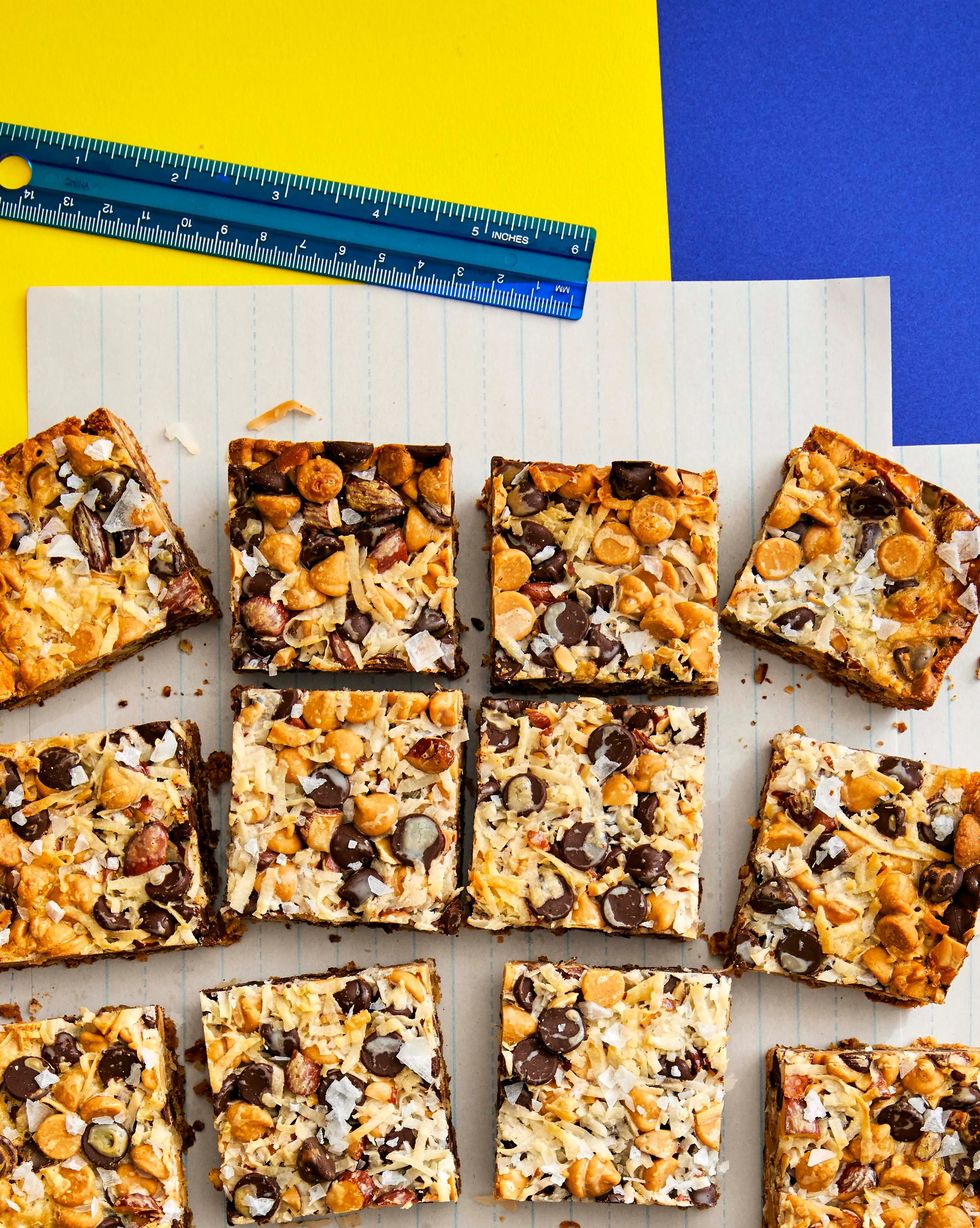 kitchen sink layer bars cut into squares and arranged on a sheet of paper
