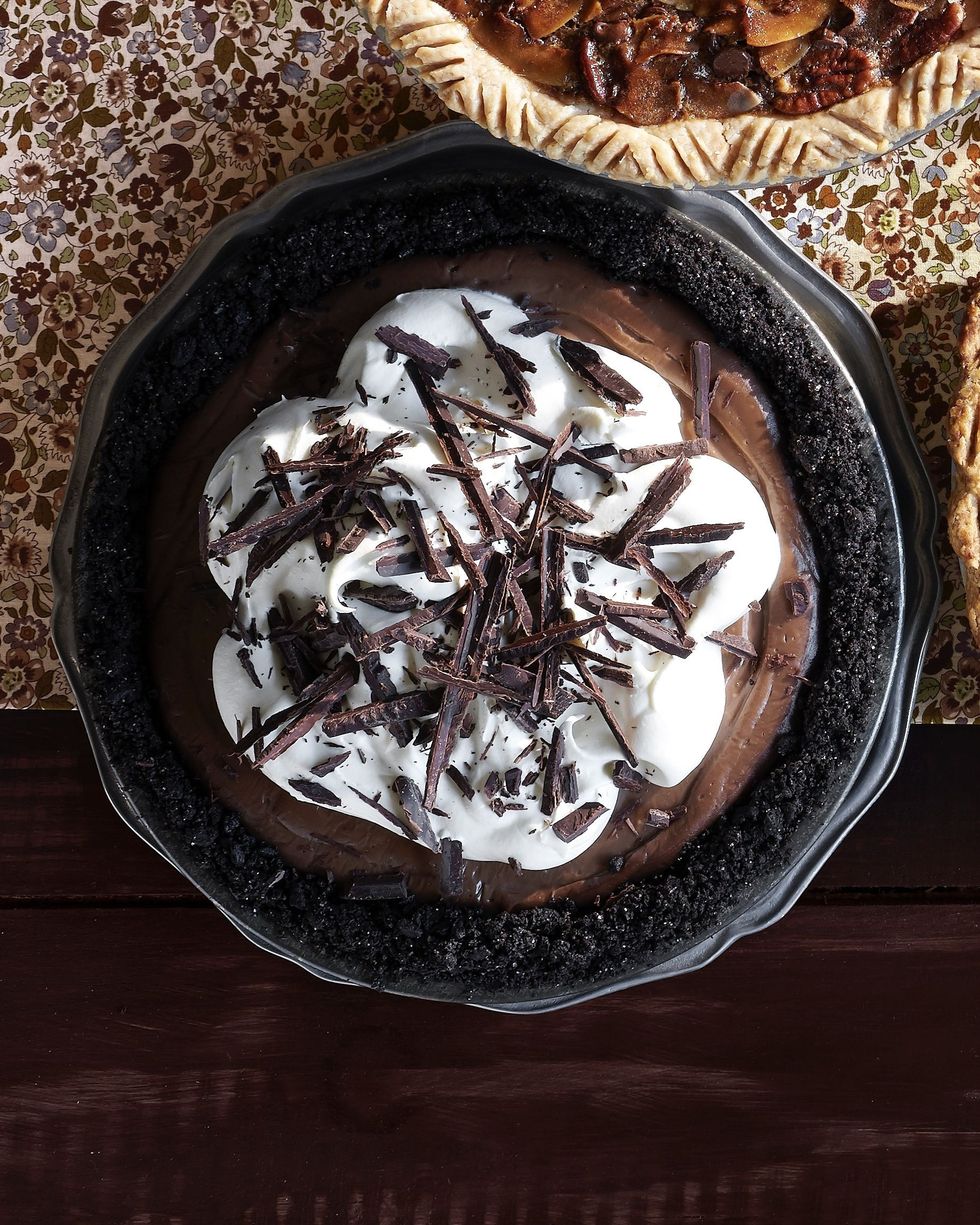 mocha cream pie topped with whipped cream and shaved chocolate