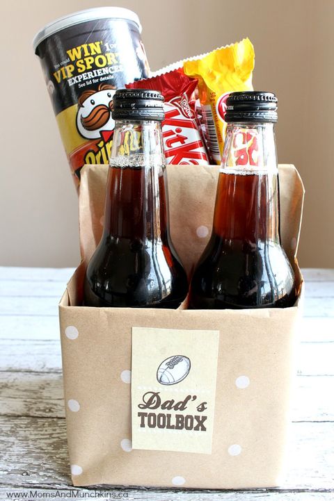 4 pack carton wrapped in polka dot brown craft paper, filled with two beers, pringles chips, kitkats and other snacks, labelled dad's toolbox