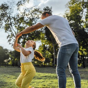 father and daughter playing together in the park