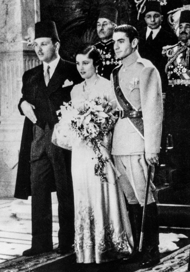 the crown prince of iran right stands beside the princess fawzia, his bride, who is escorted on the left by her brother, king farouk of egypt, after the wedding at the arbin palace  according to the muslim custom  this wedding ceremony was not attended by the princess  the marriage incidentally furnishes a bond between the two islamic countries  photo by bettmann archivegetty images