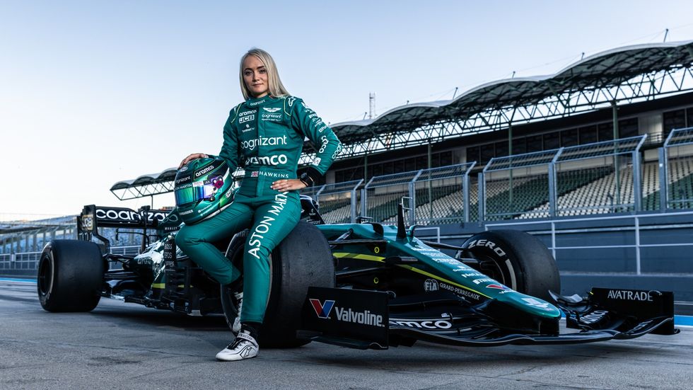 jessica hawkins poses with the aston martin amr21