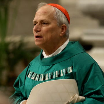 Cardinal Robert Prevost, now Pope Leo XIV, attends mass in January 2025 a man in green robes and a red head covering stands and looks to the right