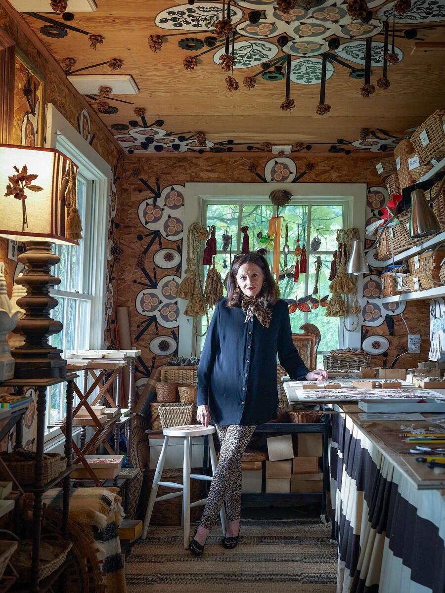 Artisan workspace featuring decorative wall designs and various crafting materials.