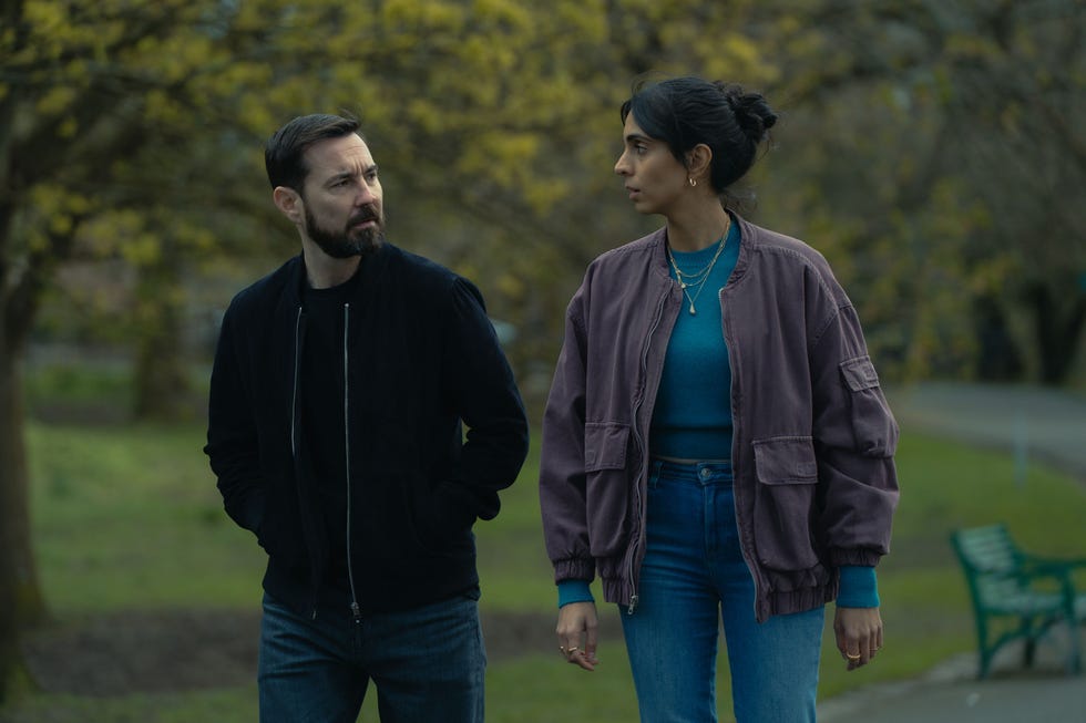 two people walking in a park setting