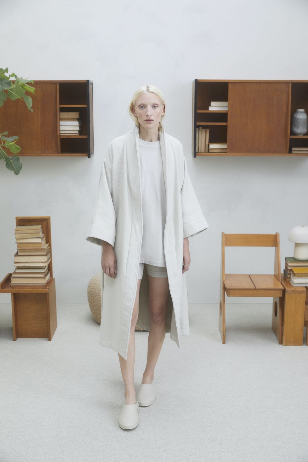 blond woman wearing fear of god home loungewear and california slides in the color cement