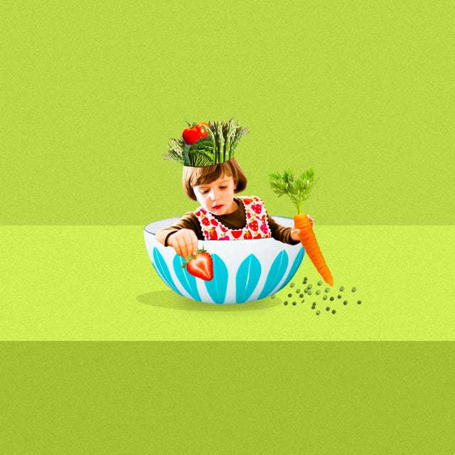 little girl sitting in a bowl holding veggies
