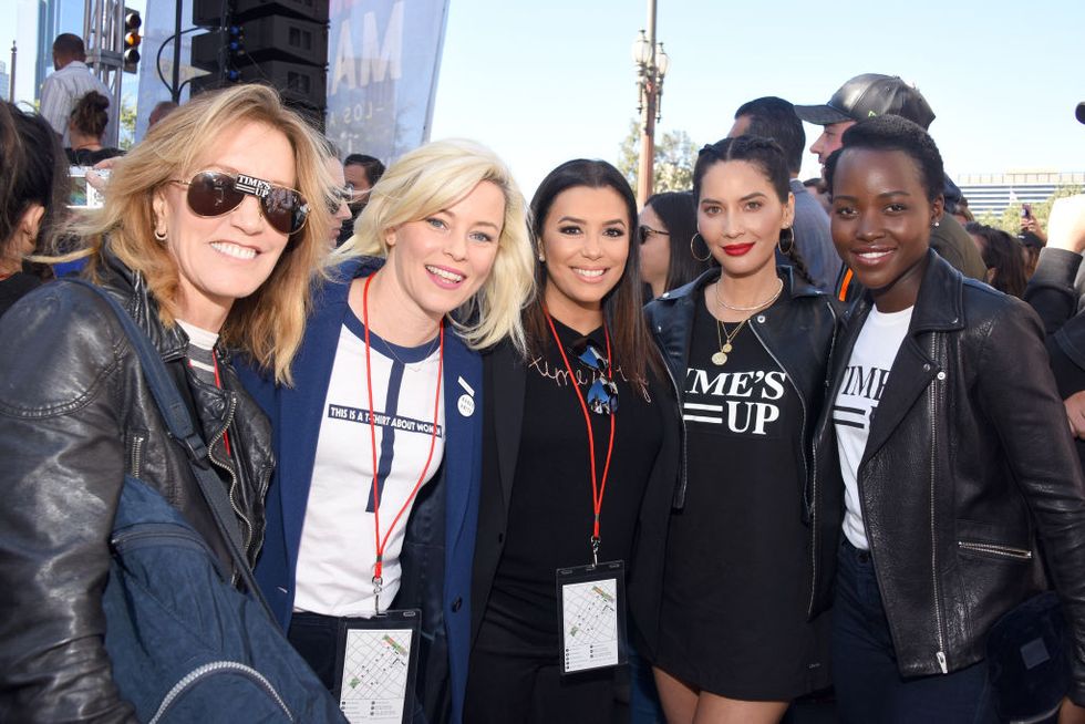 felicity huffman﻿, elizabeth banks﻿, eva longoria﻿, olivia munn, and lupita nyong'o﻿ pose for a photo with a crowd of people behind them as they stand outside