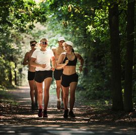 female and male pentathletes running during laser run team training for international level competition, forest