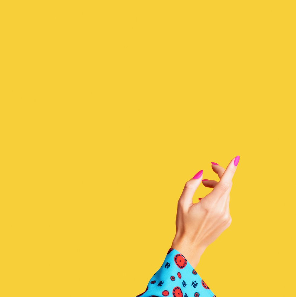 female arm and hand on yellow background