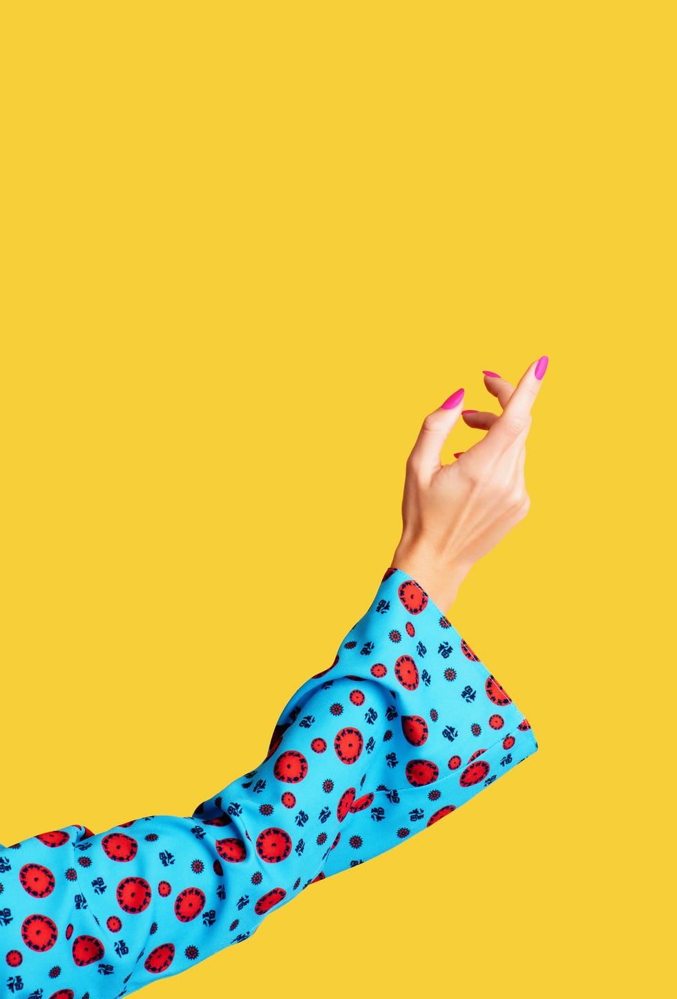 female arm and hand on yellow background