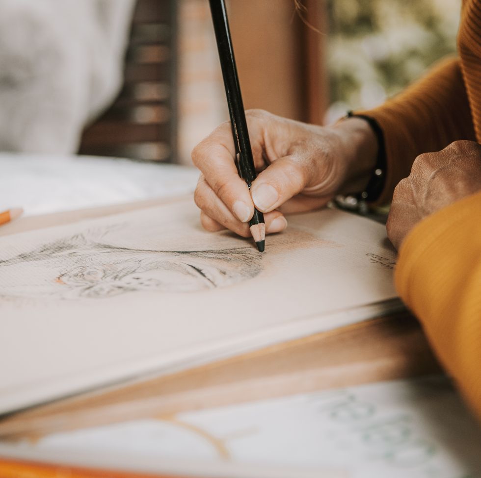 artist drawing with colored pencils in her studio
