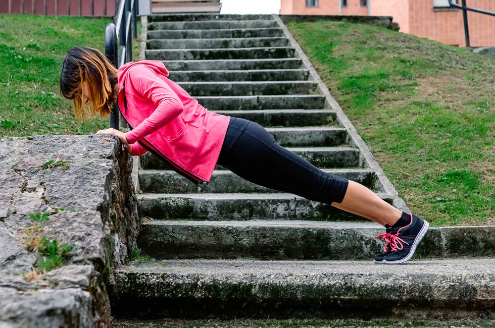 female athlete doing push ups outdoors