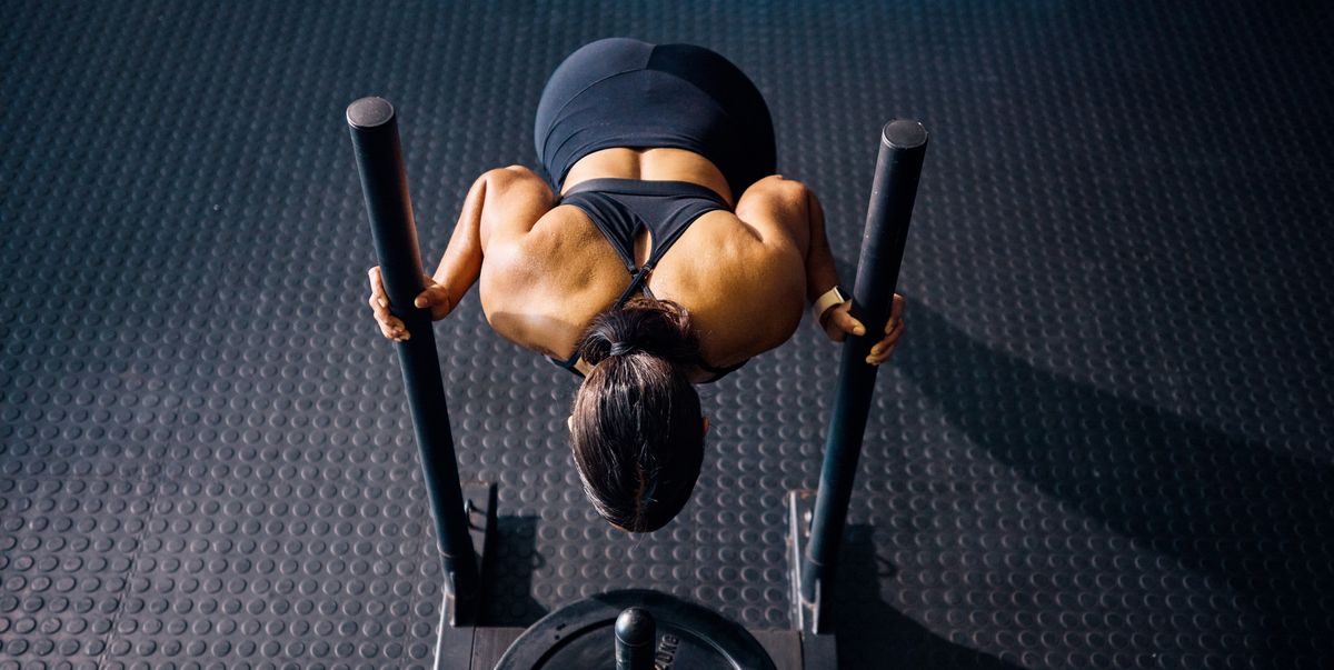 https://hips.hearstapps.com/hmg-prod/images/female-athlete-pushing-a-weighted-sled-in-a-gym-top-royalty-free-image-1755195444.pjpeg?crop=1.00xw:0.753xh;0,0.0168xh&resize=1200:*