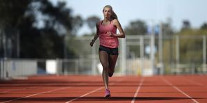 A female athlete runs on a track