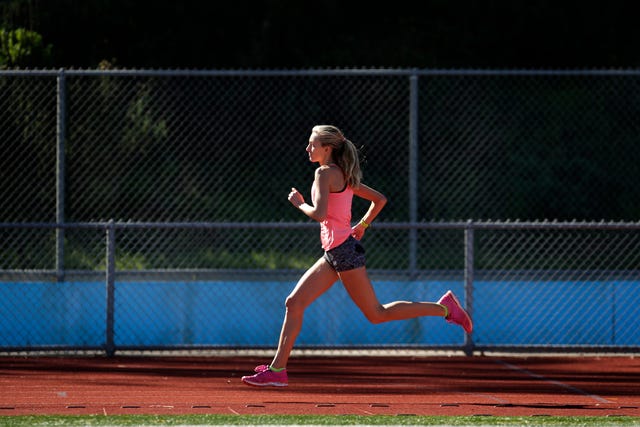 a female athlete runs on a track